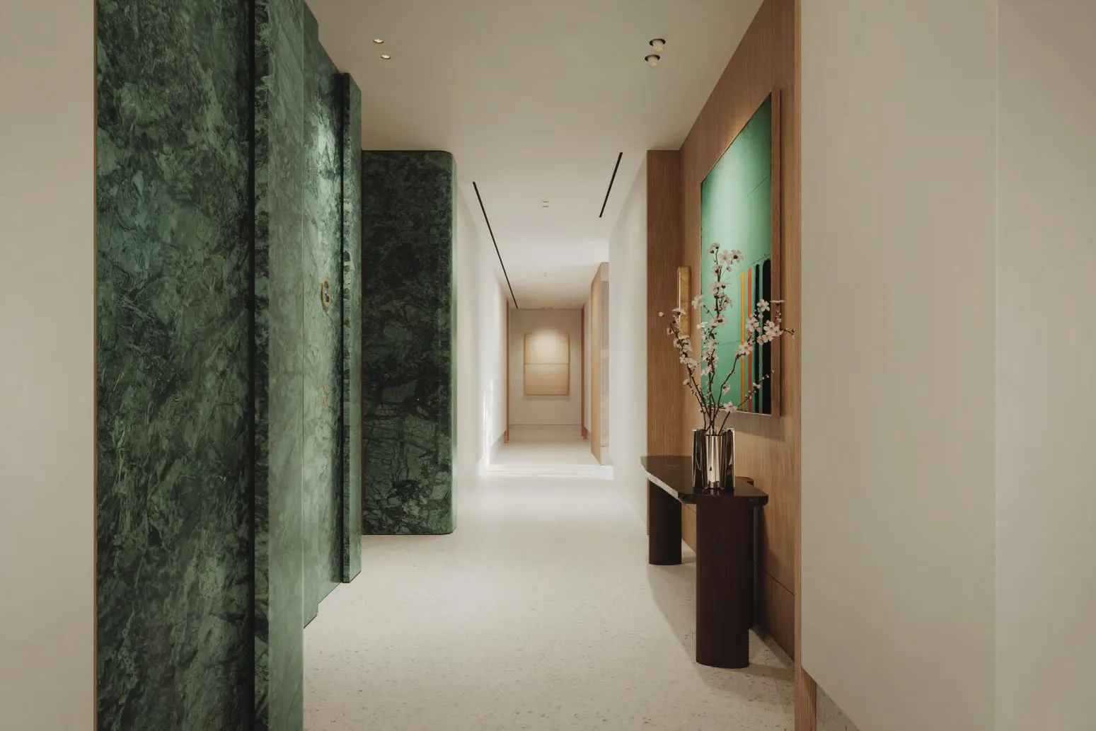 Lobby corridor with green marble walls and pale terrazzo floor